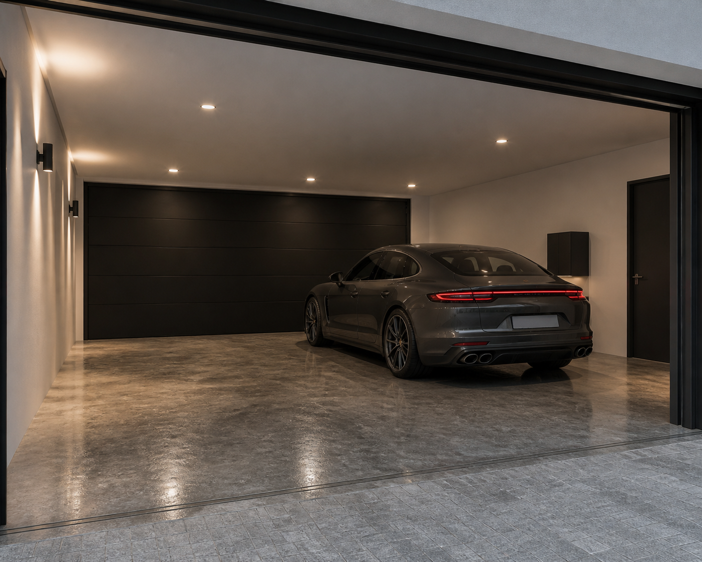 Modern residence — garage with polished concrete floor, door open to driveway
